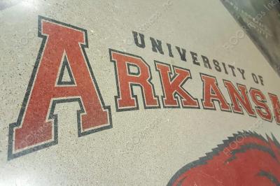 Full view of the black and red University of Arkansas Text with a small bit of blue engineering text in the background.