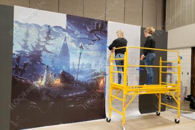 Using a small manual lift we install the 4'x 10' panels of the Halloween 80/20 perforated prints vertically to the wall.